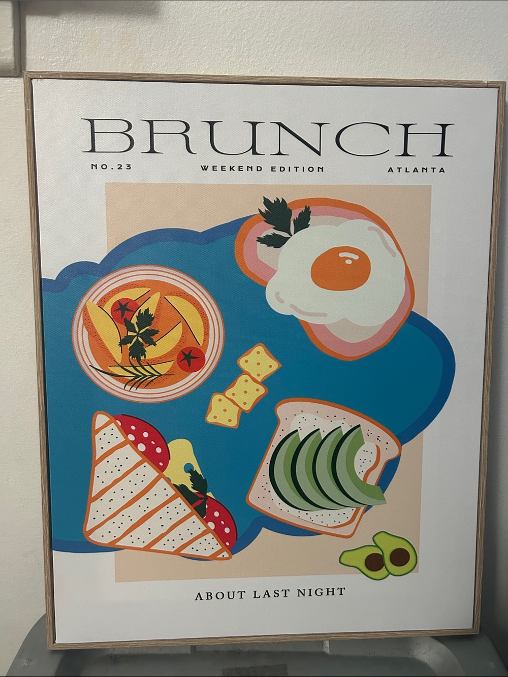 Ashland canvas wall art Brunch Weekend Edition Framed on a light wood-toned